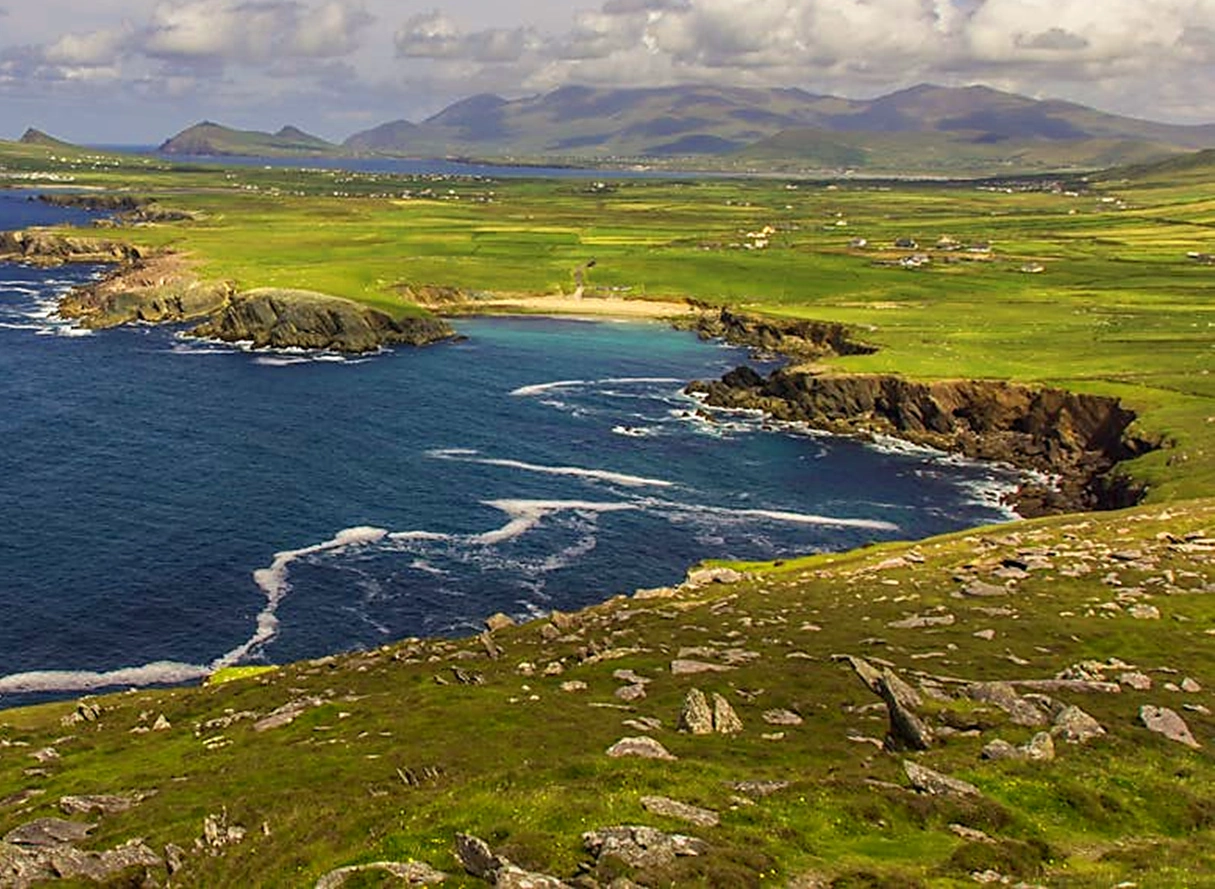 Bay with beach and sweeping Kerry coastline with mountains in background beyond