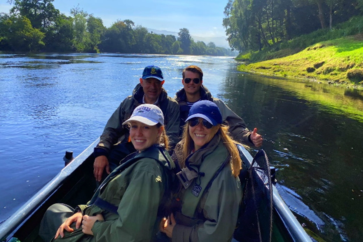 Family group in a boat on the River Tay fishing for salmon