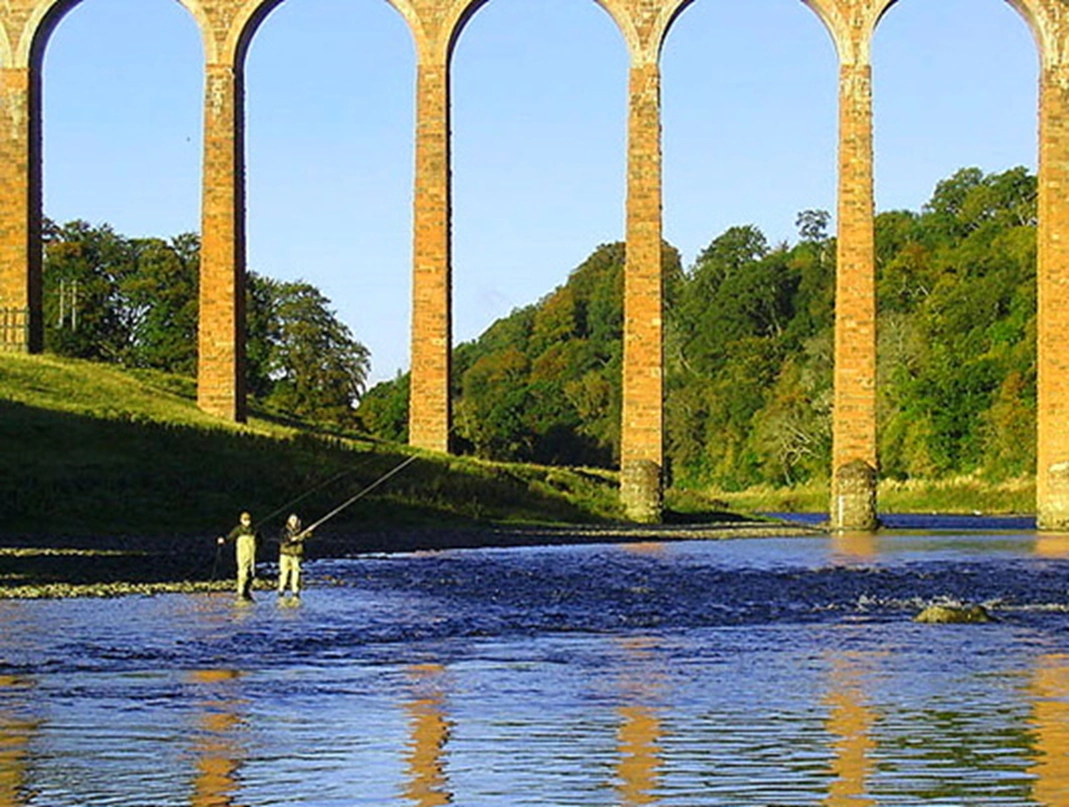 Fishermen on the Tweed with viaduct in the background