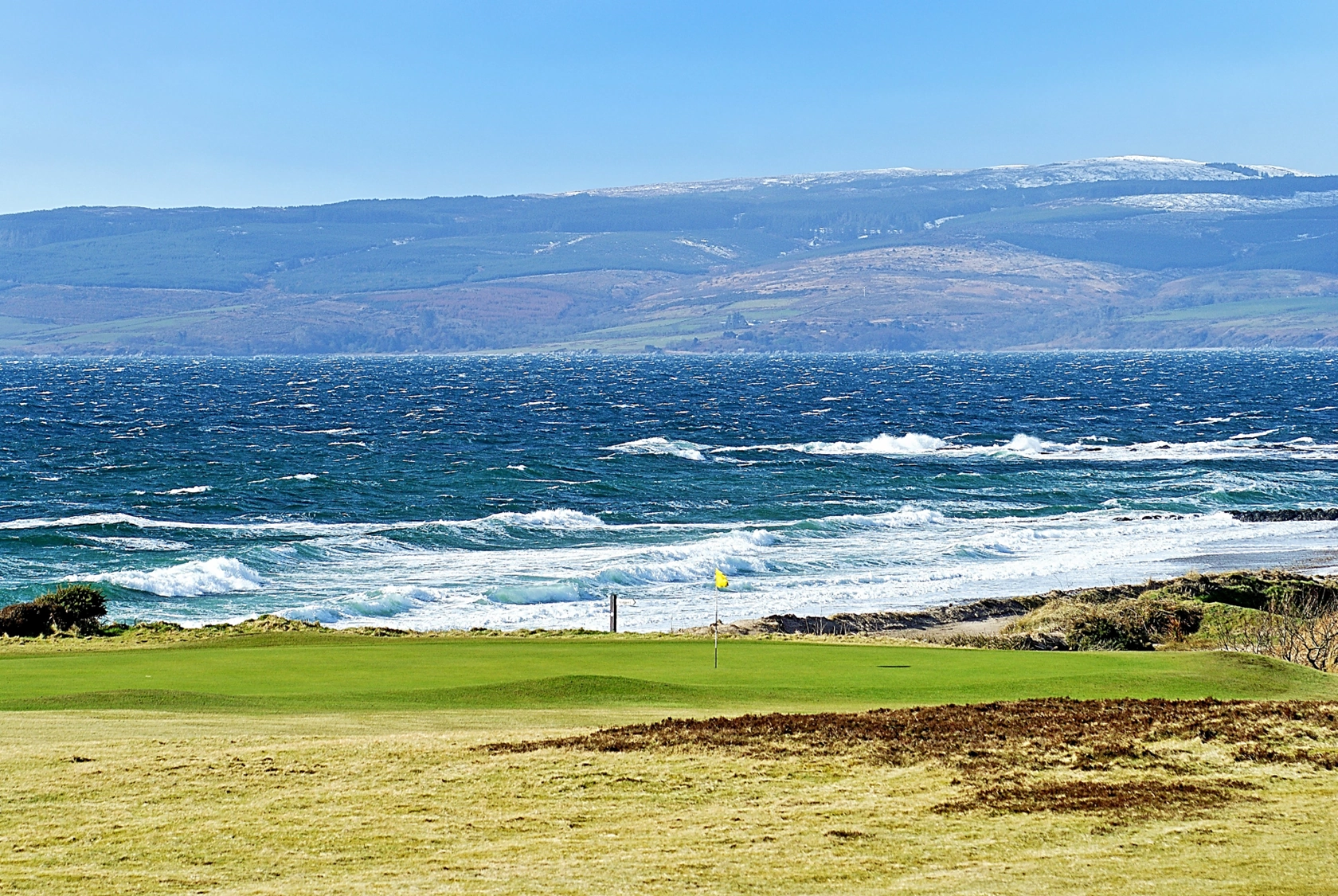 Shiskine green with wild sea in the background