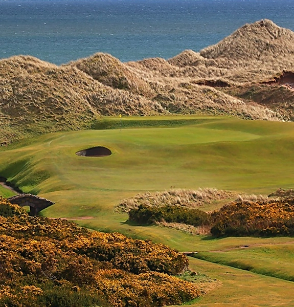 Cruden Bay 6th green seen from a distance with dunes behind