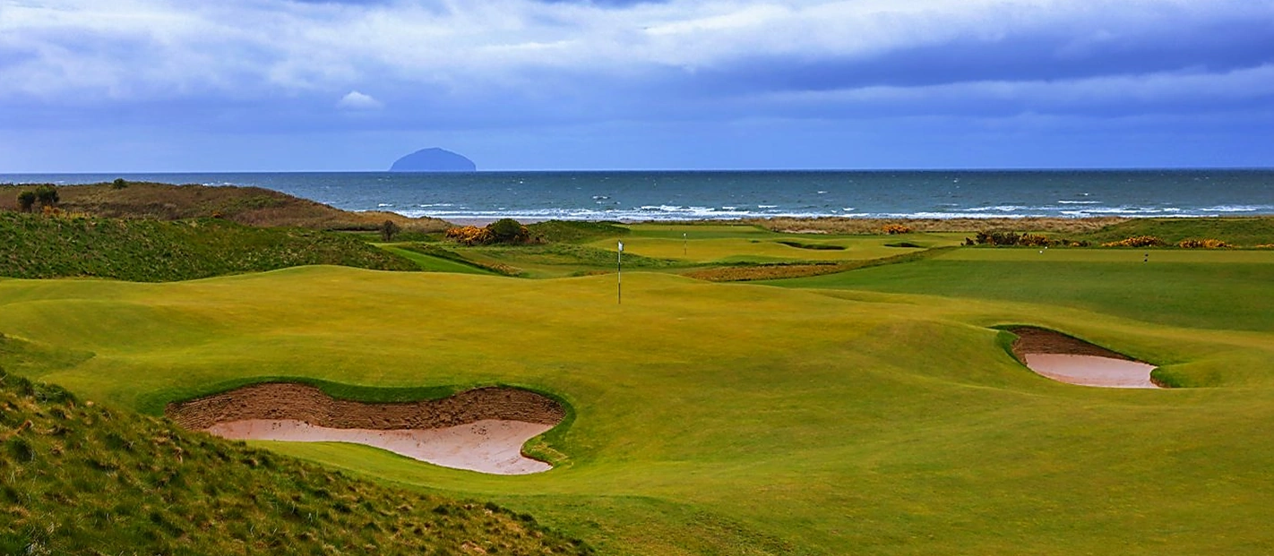 Looking across the first green at Turnberry to the sea and Ailsa Craig on the horizon