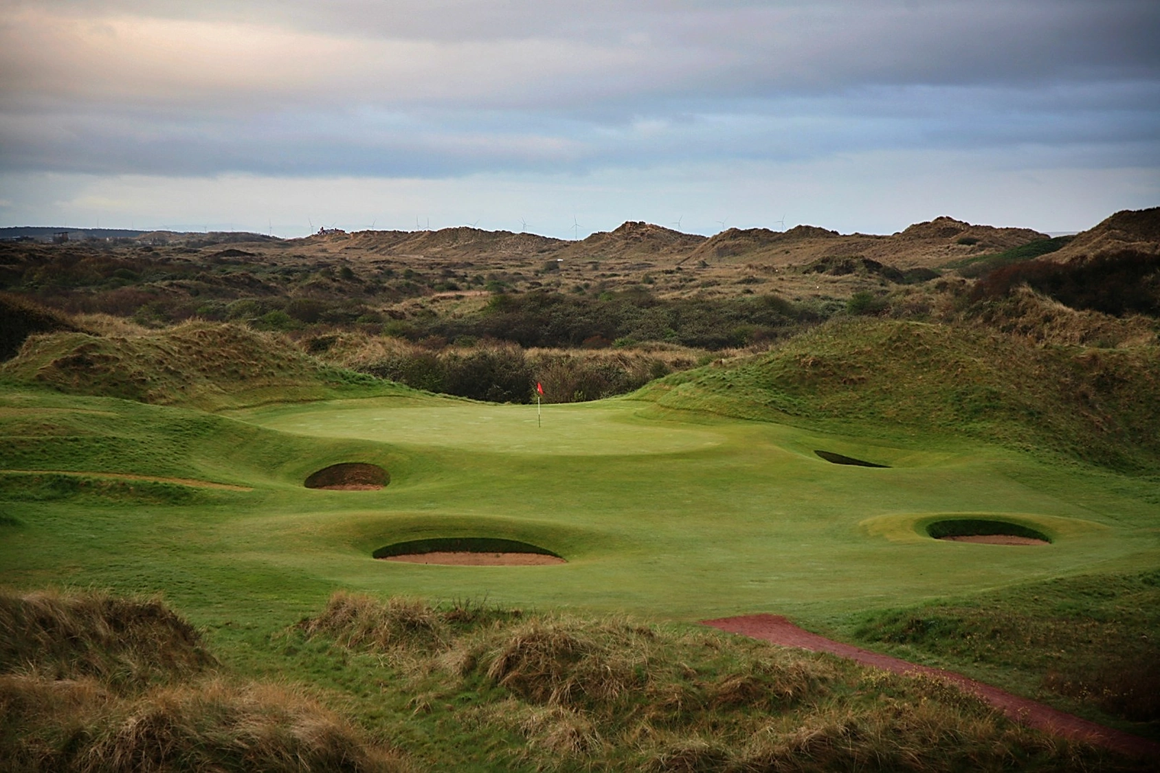 11th green at Royal Birkdale with sand dunes behind