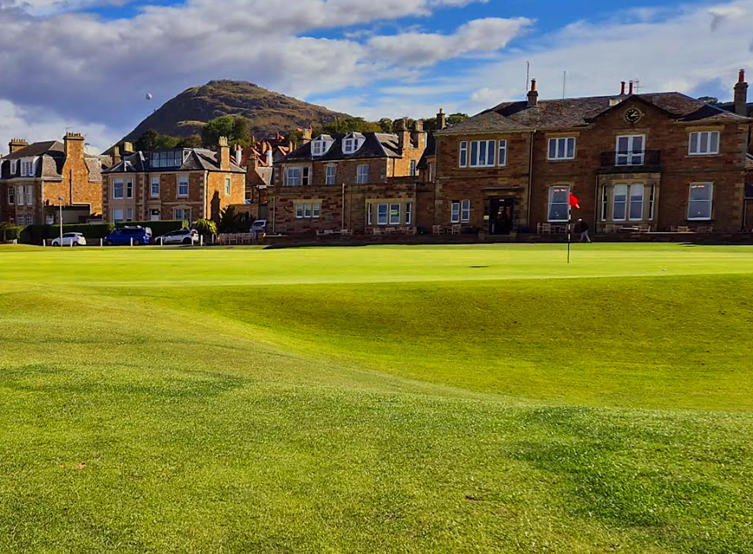 Below the 18th green at North Berwick with the clubhouse and North Berwick law in the background