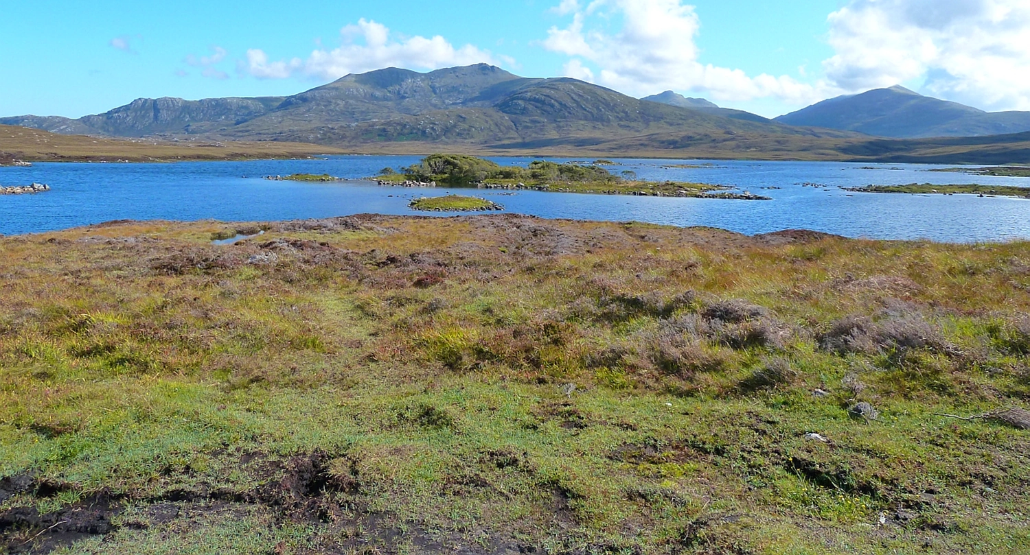 Bleak landscape on South Uist with low mountain and lake