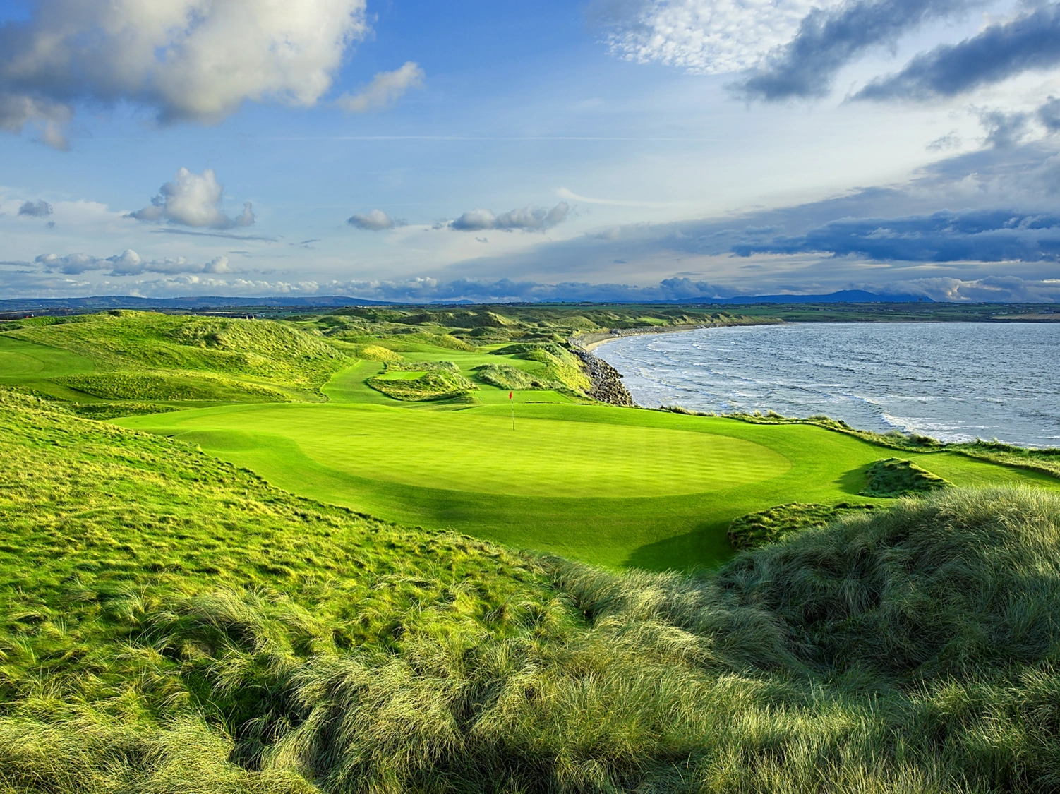 11th green at Ballybunion with sea in the background