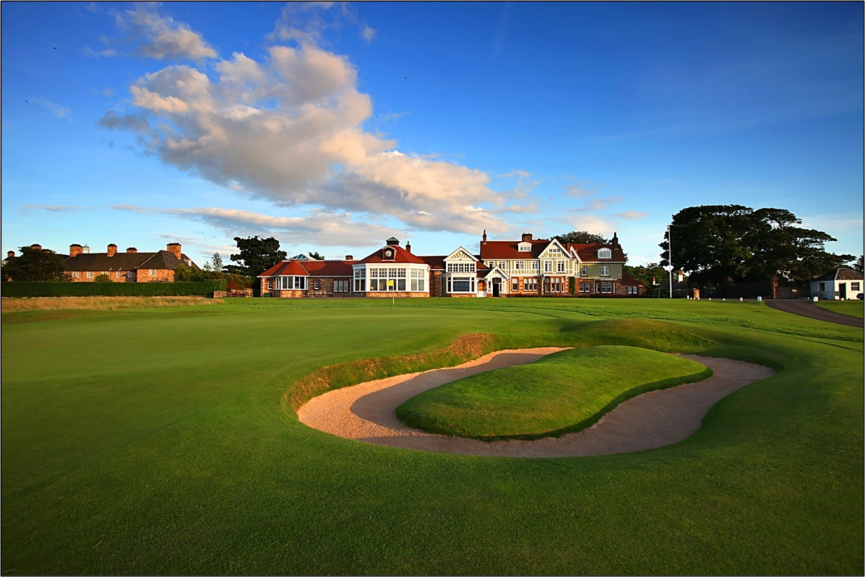 Muirfield 18th green with clubhouse in the background and doughnut bunker in the foreground