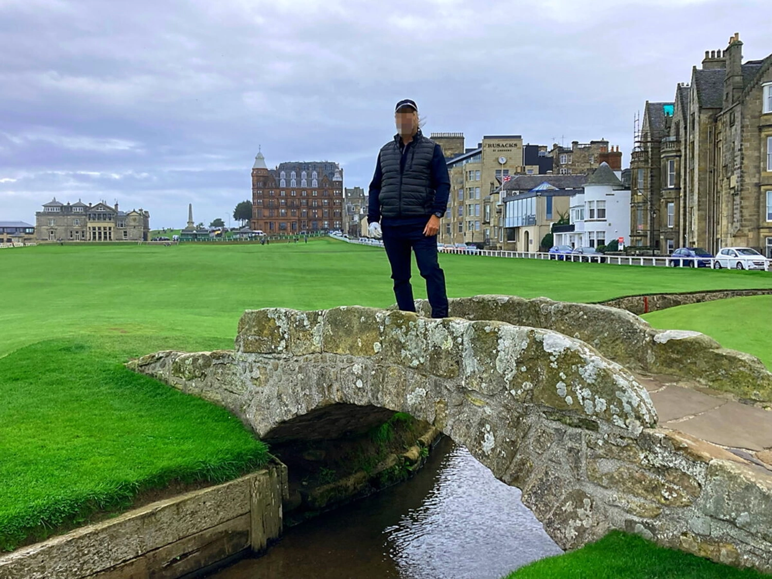 Golfer standing on the Swilcan bridge