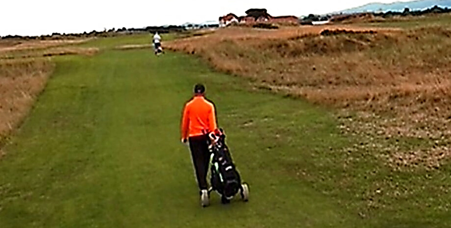 Golfer walking up the fairway at Portmarnock