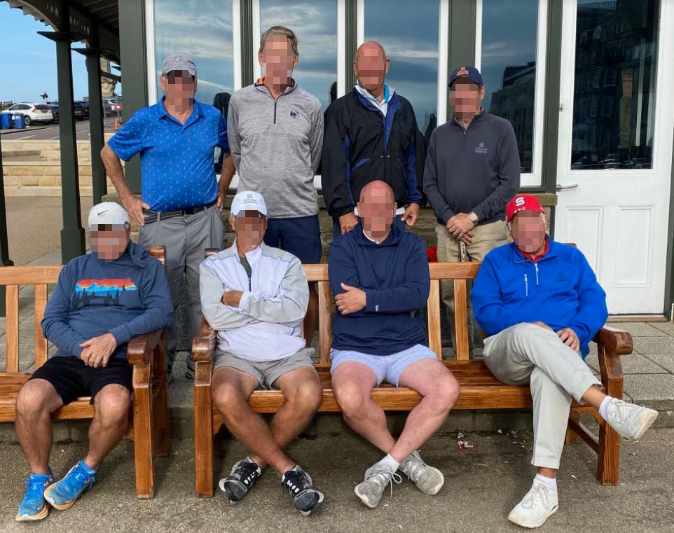 eight golfers sitting outside the Old Pavilion in St Andrews