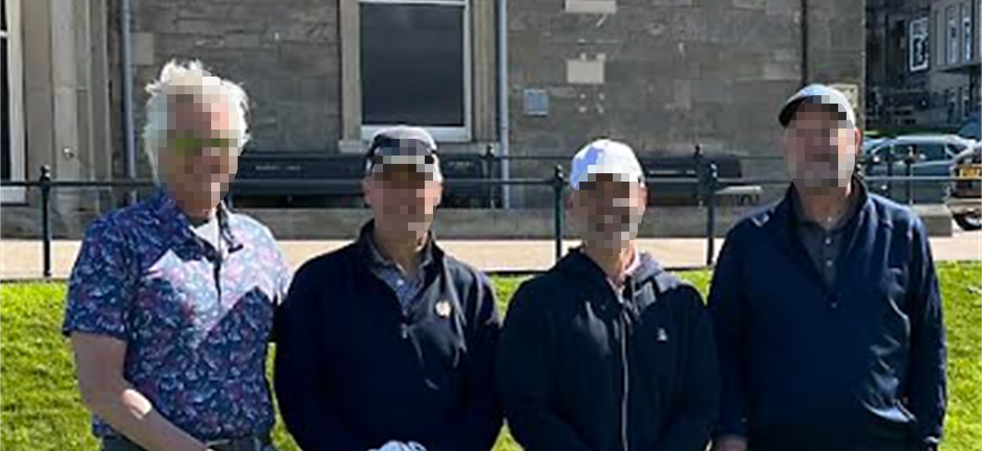 Golfers standing outside the R&A building