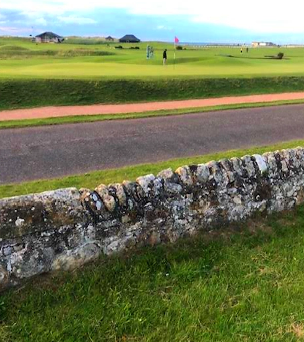 looking back to the 17th green with the stonewall and road in the foreground